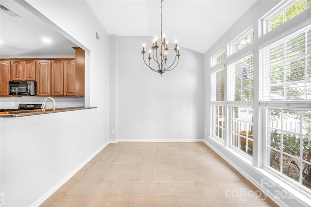 unfurnished dining area with light tile patterned floors, a chandelier, and vaulted ceiling