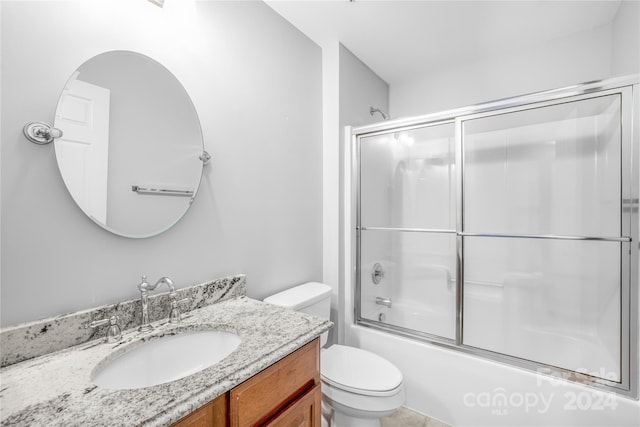 full bathroom featuring toilet, enclosed tub / shower combo, and vanity