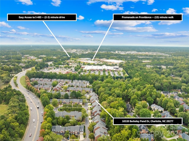 bird's eye view with a residential view and a wooded view