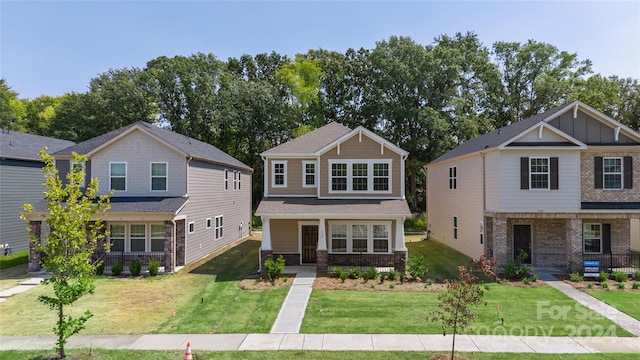 craftsman-style home featuring a front yard, covered porch, and central air condition unit