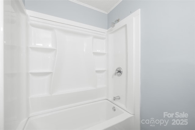 bathroom with shower / tub combination and a textured ceiling