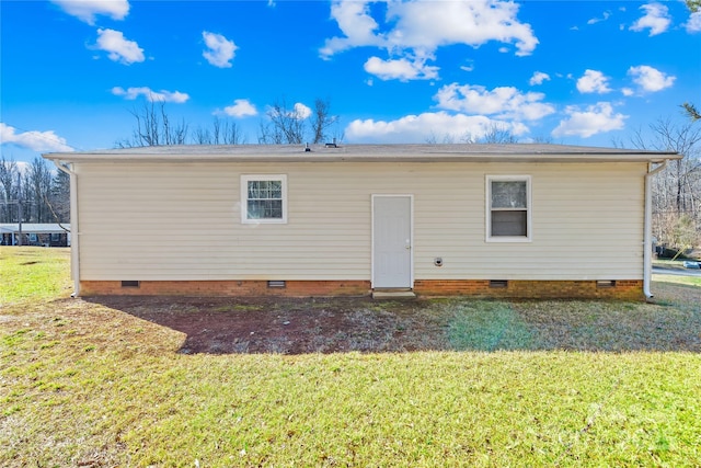 rear view of property featuring a yard