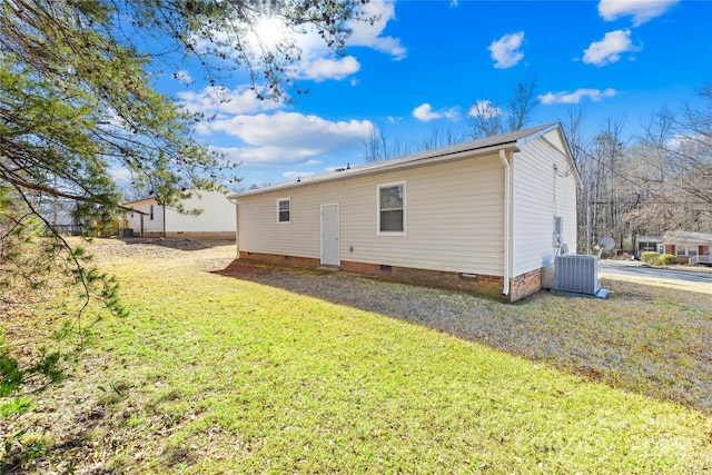 rear view of house featuring a yard and central AC