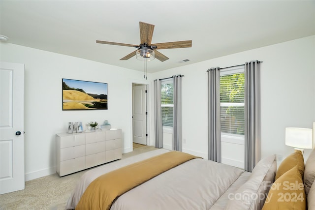 bedroom with light carpet and ceiling fan