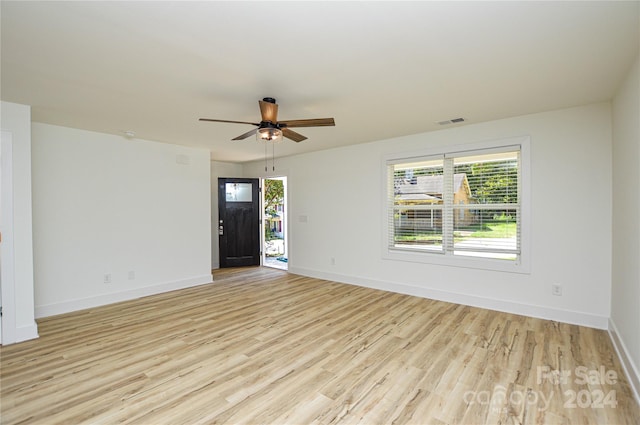 empty room featuring ceiling fan and light hardwood / wood-style floors