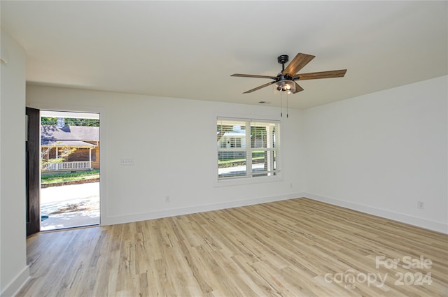 spare room featuring light hardwood / wood-style floors, ceiling fan, and plenty of natural light