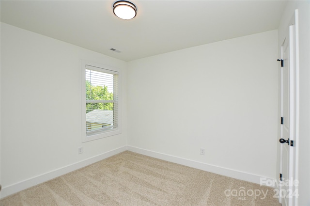 unfurnished room with light carpet