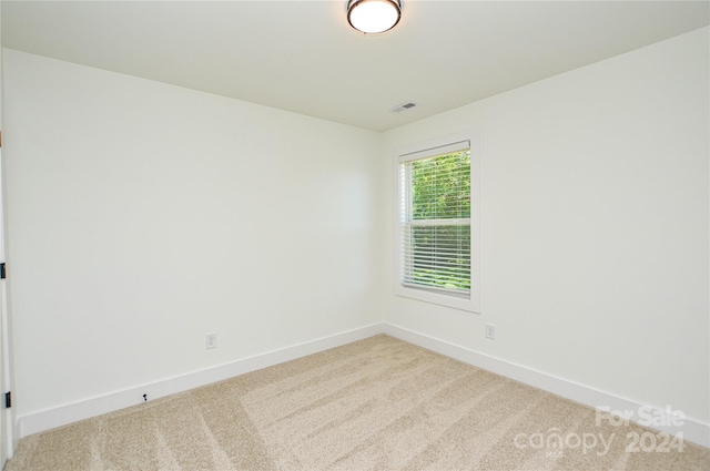 empty room featuring light carpet