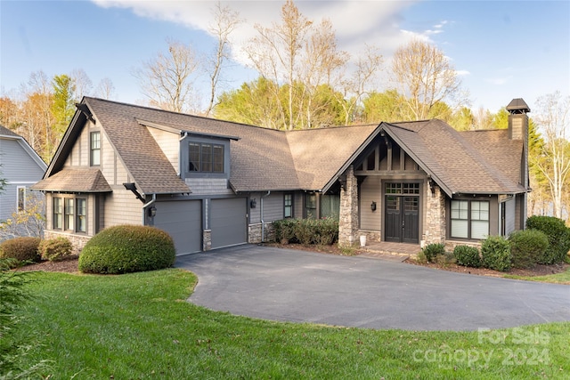 view of front of property with a front lawn and a garage