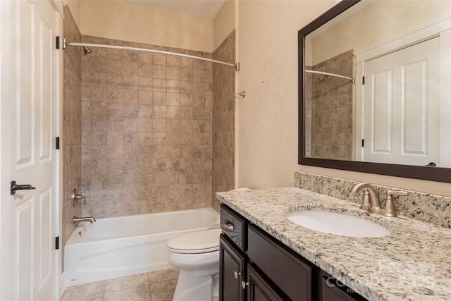 full bathroom with tiled shower / bath combo, vanity, tile patterned floors, and toilet