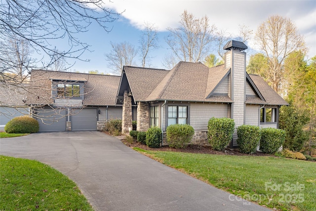 view of side of property with a garage and a lawn