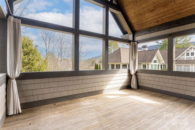 unfurnished sunroom with lofted ceiling and wooden ceiling