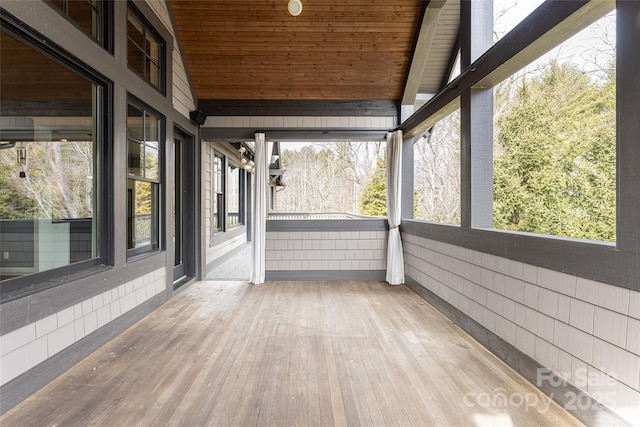 unfurnished sunroom with wood ceiling and lofted ceiling