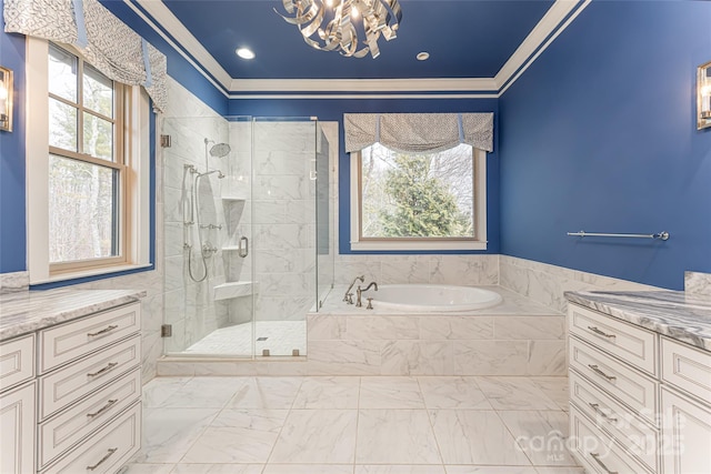 bathroom featuring shower with separate bathtub, a healthy amount of sunlight, vanity, and a chandelier