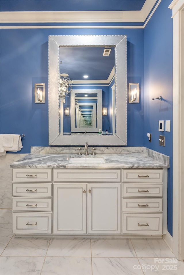 bathroom with crown molding and vanity