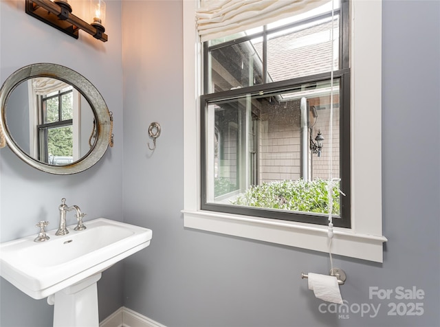 bathroom featuring plenty of natural light and sink