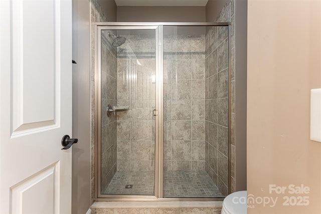 bathroom with toilet and walk in shower