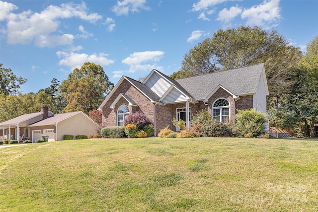 view of front facade with a front yard and a garage