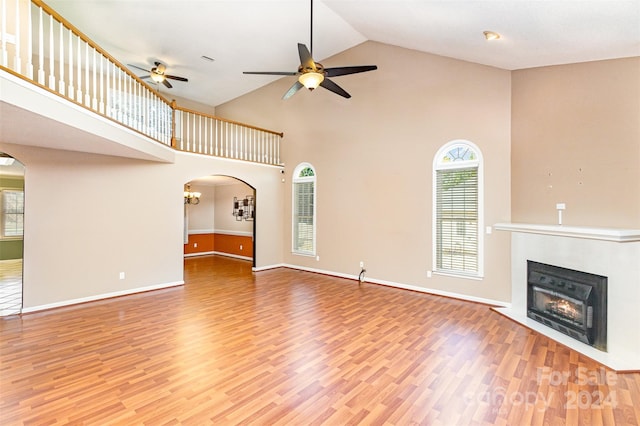 unfurnished living room featuring ceiling fan, hardwood / wood-style flooring, and high vaulted ceiling