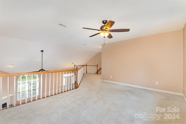 spare room featuring light carpet, ceiling fan, and lofted ceiling