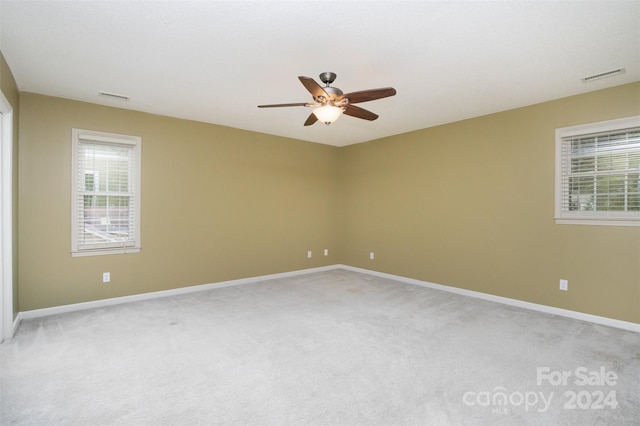 carpeted spare room with ceiling fan