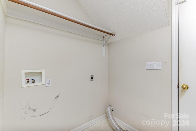 laundry room with hookup for a washing machine, a textured ceiling, and hookup for an electric dryer