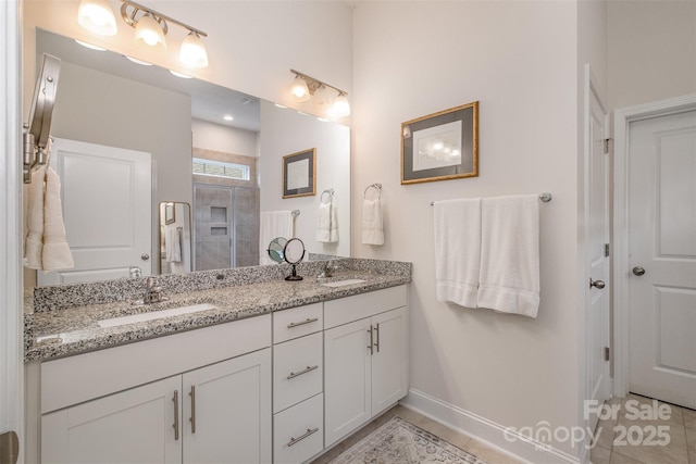 bathroom featuring walk in shower, tile patterned floors, and vanity