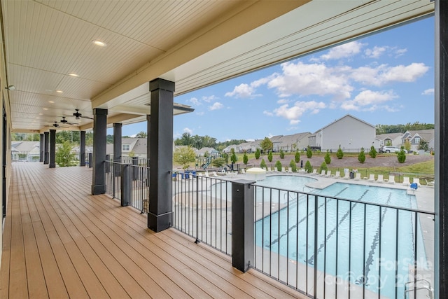 wooden terrace with a community pool