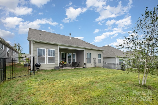 rear view of property with a patio area and a lawn