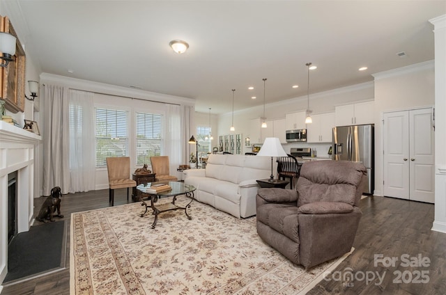 living room featuring crown molding, hardwood / wood-style flooring, and a high end fireplace