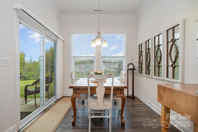 dining area featuring plenty of natural light, dark hardwood / wood-style floors, and crown molding