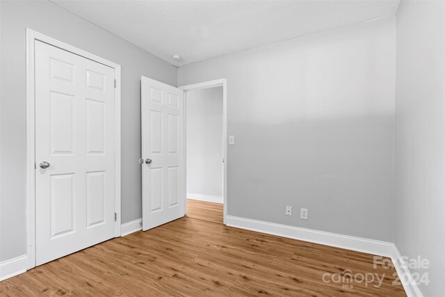 unfurnished bedroom with light wood-type flooring