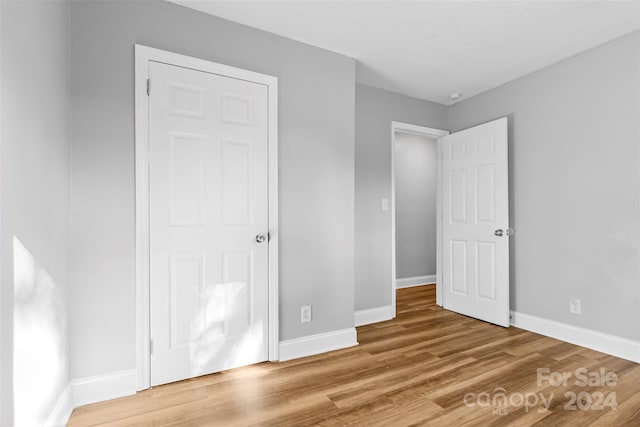 unfurnished bedroom with hardwood / wood-style floors