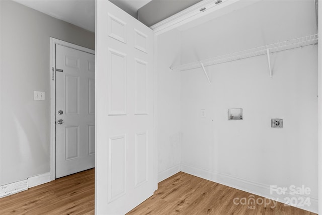 laundry area with hookup for a washing machine, hardwood / wood-style floors, and electric dryer hookup