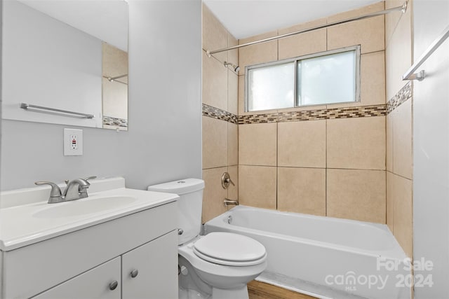 full bathroom with tiled shower / bath, vanity, toilet, and wood-type flooring