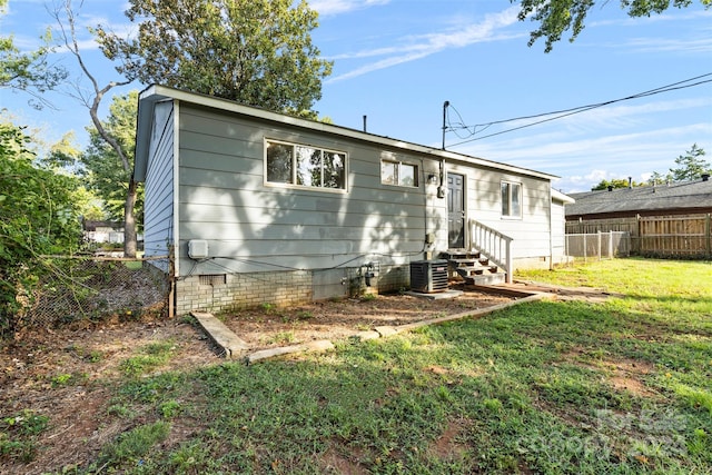 view of front of property featuring entry steps, a front yard, fence, and crawl space