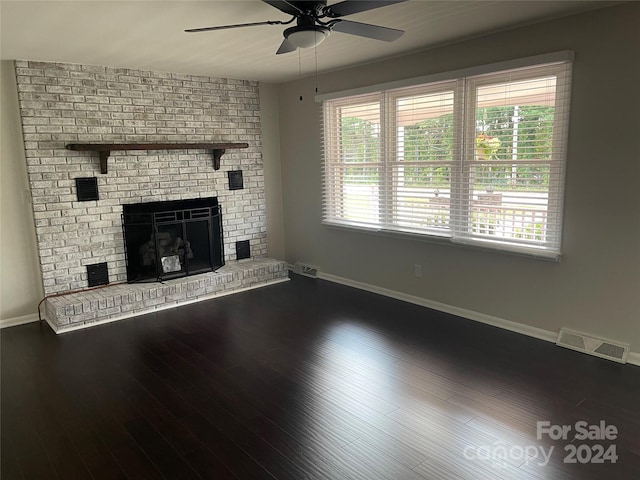 unfurnished living room featuring a brick fireplace, hardwood / wood-style floors, and ceiling fan