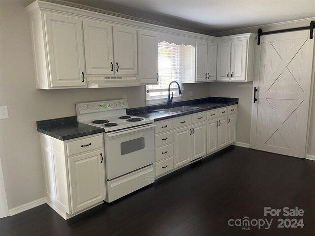 kitchen featuring white cabinets, a barn door, white range with electric cooktop, sink, and dark wood-type flooring