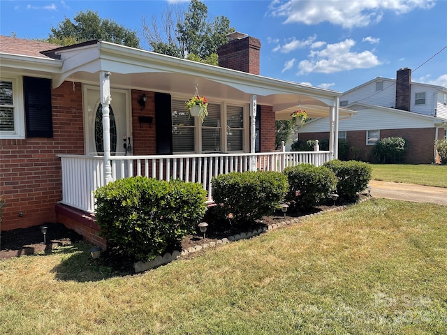 view of front facade with a front yard and a porch