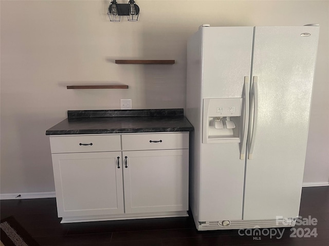 interior space featuring white cabinets, dark hardwood / wood-style flooring, and white fridge with ice dispenser