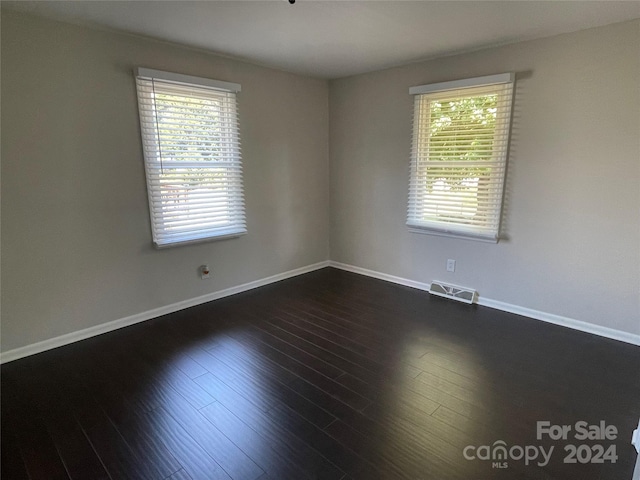 empty room featuring dark hardwood / wood-style flooring