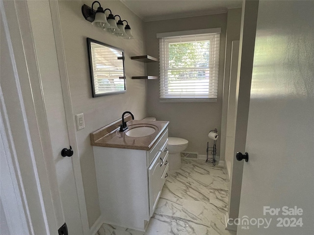 bathroom featuring toilet and vanity