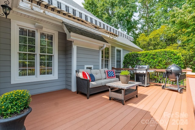 wooden deck featuring outdoor lounge area and a grill