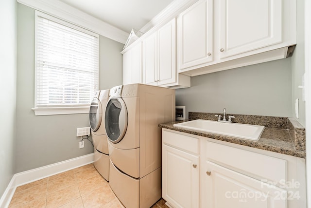 laundry room featuring cabinets, separate washer and dryer, light tile patterned flooring, and sink