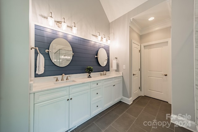 bathroom featuring tile patterned flooring, vanity, lofted ceiling, and crown molding