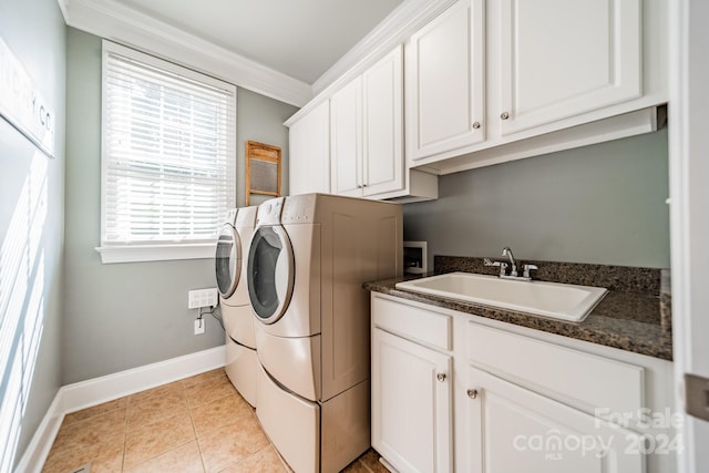 laundry area with cabinets, ornamental molding, sink, light tile patterned floors, and washing machine and clothes dryer