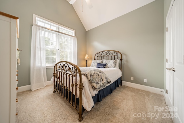 carpeted bedroom featuring ceiling fan, a closet, and vaulted ceiling