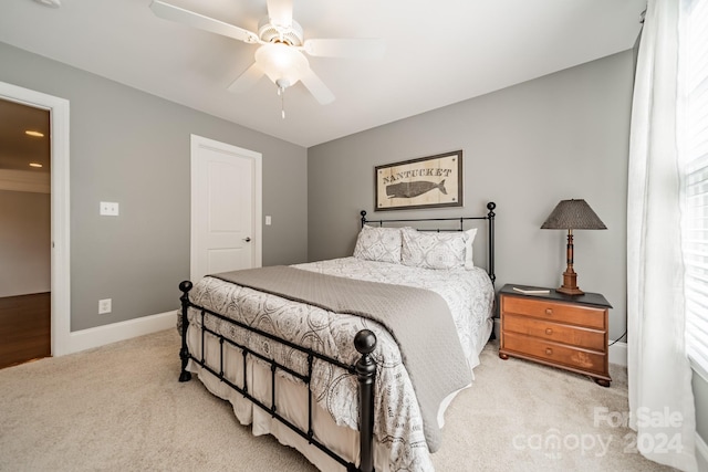 bedroom with light colored carpet and ceiling fan