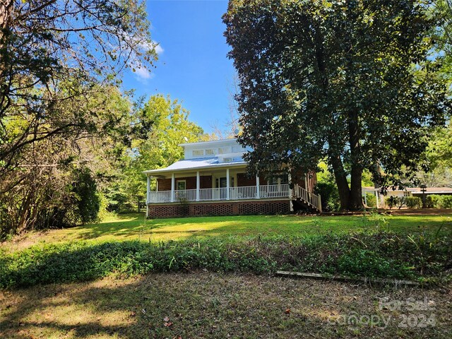 exterior space with a front yard and a porch