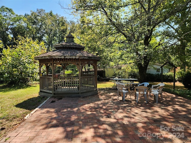 exterior space featuring a gazebo and outdoor dining space